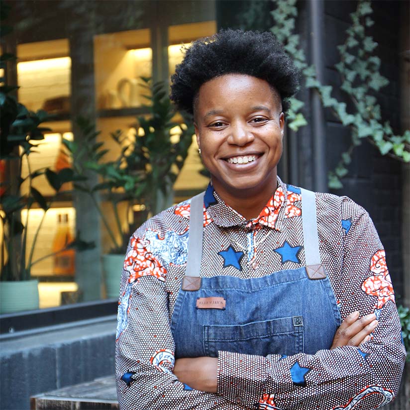 a person smiling with the arms crossed
