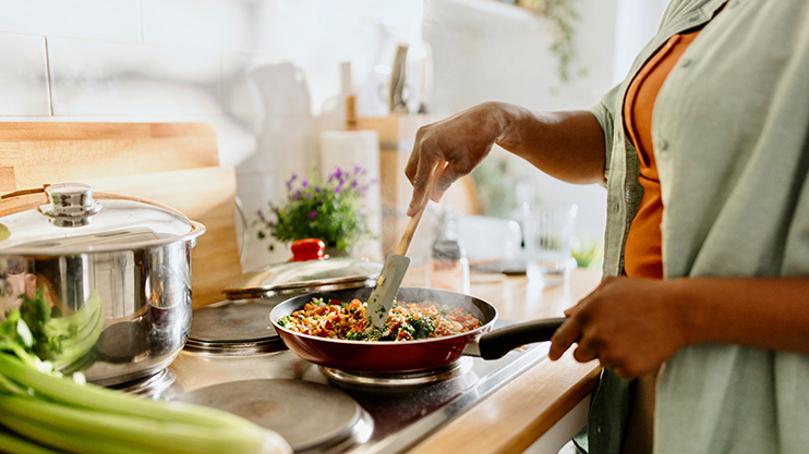 a person cooking food on a stove